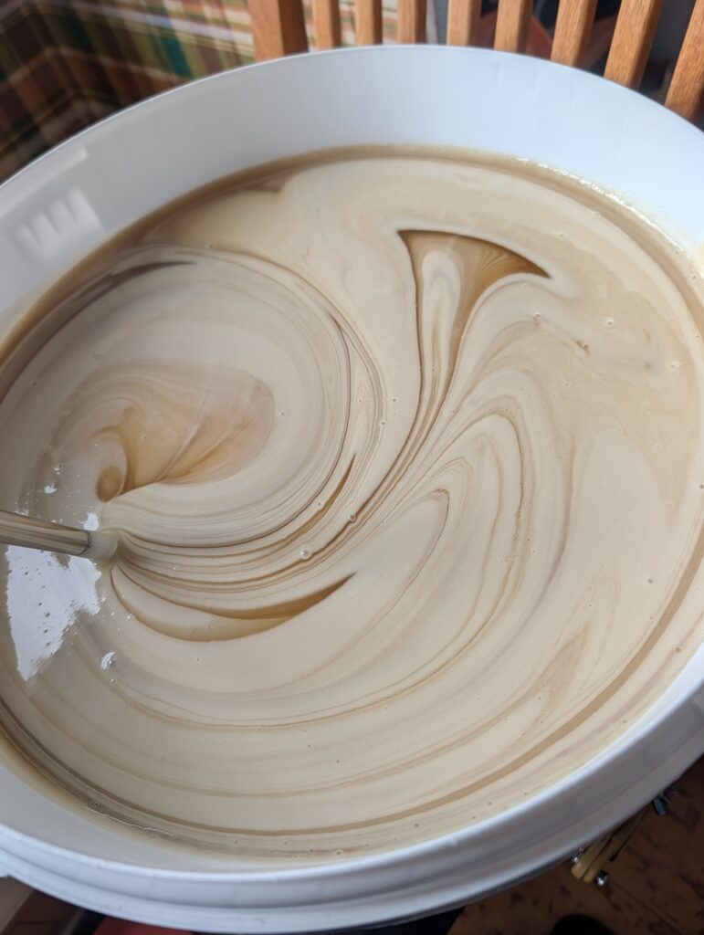 Creamed honey being stirred during seeding